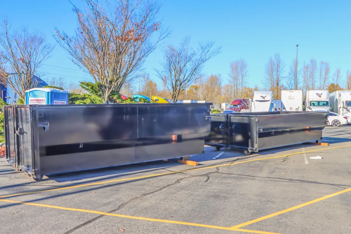 Professional dumpster rental service with roll-off container on residential driveway in Fishersville